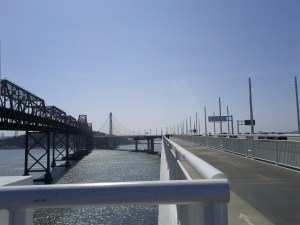The old and new spans of the Oakland Bay Bridge with the bike trail on the left.